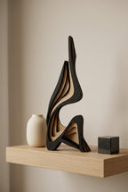 Sculptural object on a wooden surface with a blurred background