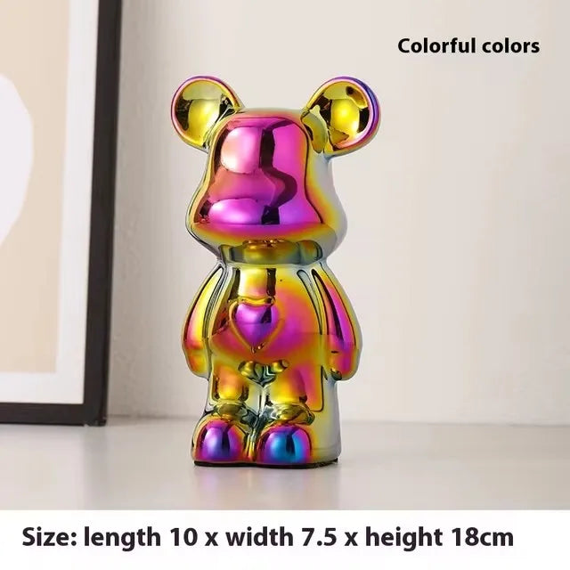 A glossy iridescent bear-shaped figurine with shifting pink, purple, yellow, and blue tones, shown standing on a light surface indoors. Text in the image highlights colorful colors and size measurements.