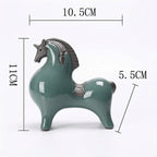 A glossy teal horse figurine shown with dimension lines and Chinese text indicating its measurements: 10.5 cm in length, 11 cm in height, and 5.
