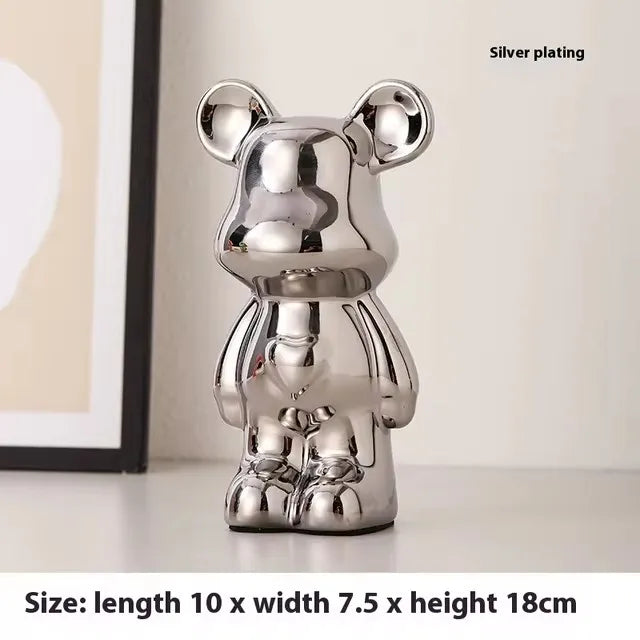 A shiny silver bear-shaped decorative object with a reflective metallic finish, shown standing on a light surface indoors. Text in the top right says 'Silver plating,' and text at the bottom says size: length 10 x width 7.