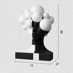 A black and white sculptural bust with a glossy black face and neck, white hair-like spheres, and a rectangular base, shown on a light gray grid background with dimension labels reading 30 cm height, 11 cm width, and 17 cm length.