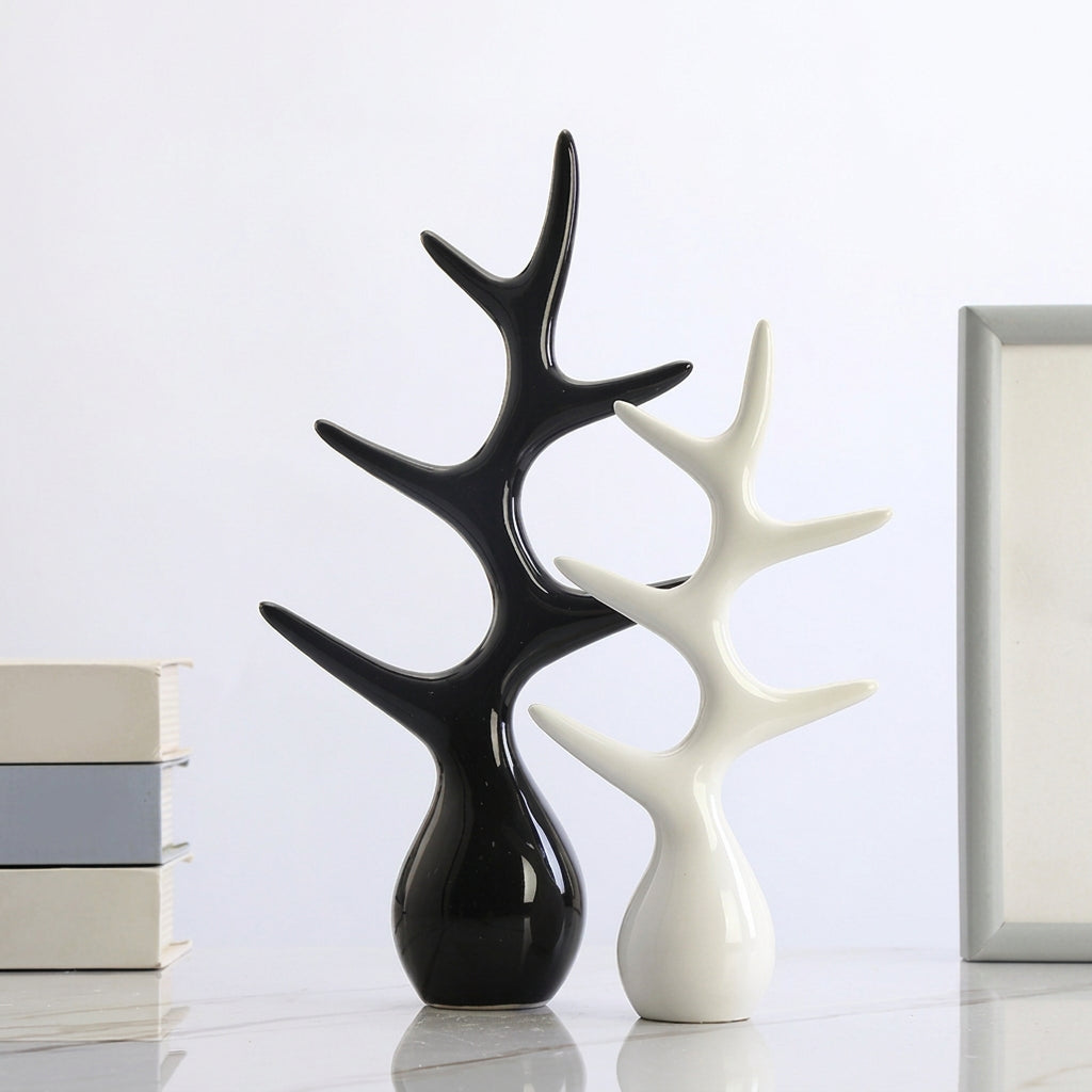 Two glossy tree-shaped decorative sculptures, one black and one white, displayed on a light surface against a white background. A text box in the upper right shows dimensions in Chinese, and books are partially visible on the left.