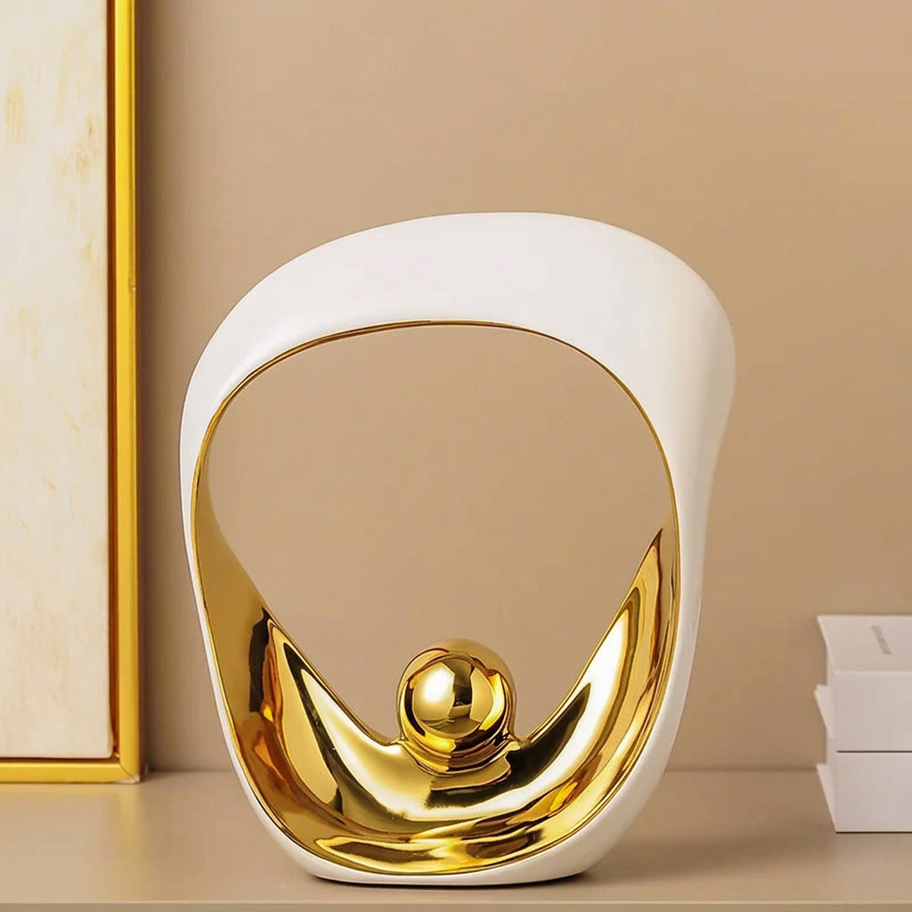 Decorative item with gold and white design on a beige background