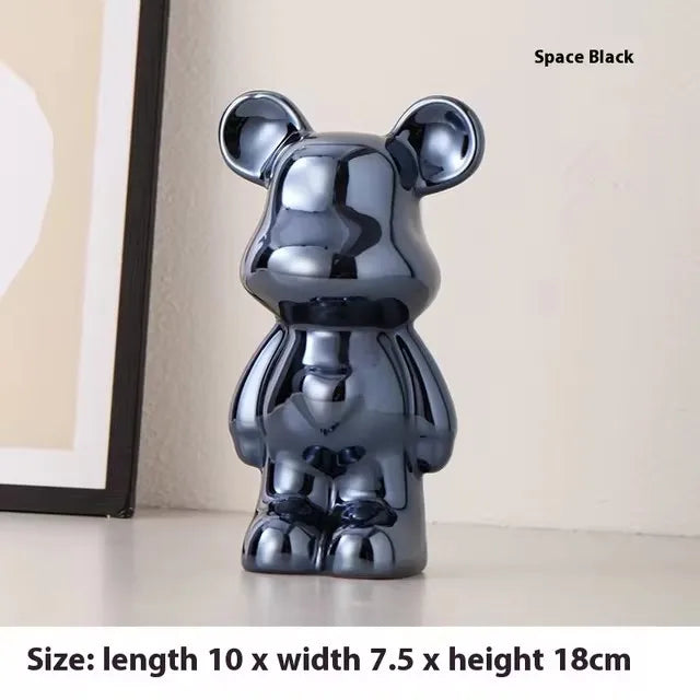 A glossy black bear-shaped figurine or decor object standing on a tabletop, with framed wall art partly visible behind it. Text in the top right reads 'Space Black,' and a bottom text strip shows dimensions: length 10 x width 7.