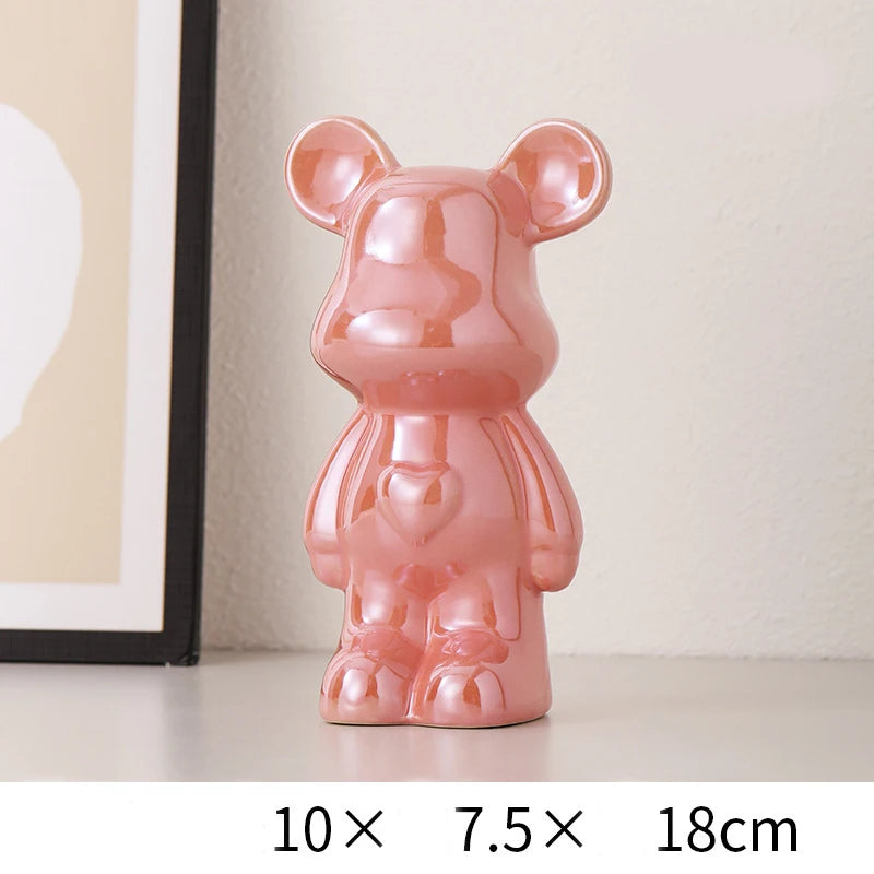 Pink bear-shaped decorative item on a white surface with dimensions displayed.