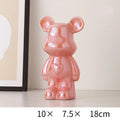 Pink bear-shaped decorative item on a white surface with dimensions displayed.