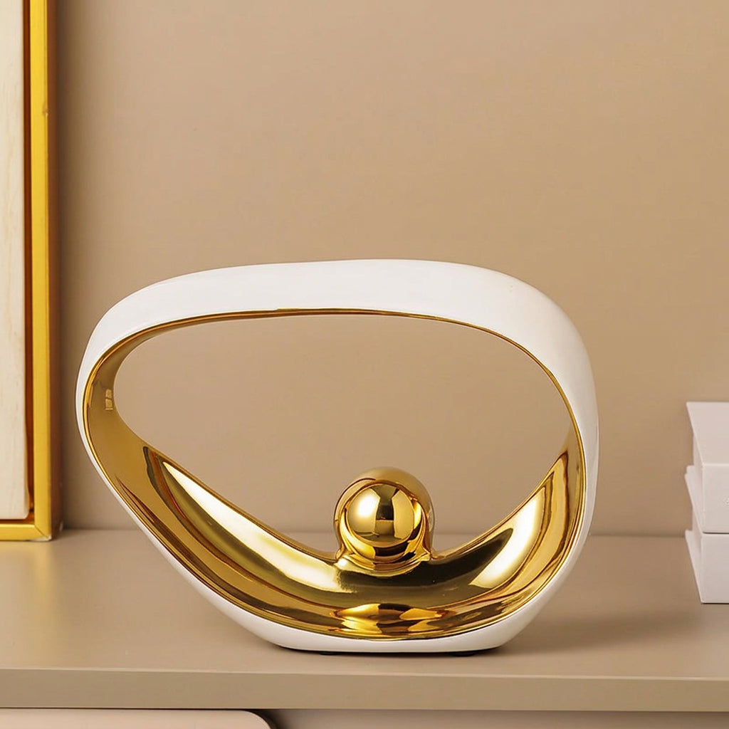 Decorative bowl with gold and white design on a beige background