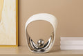 Decorative item with a gold frame and text on a beige background